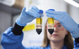 A researcher in a laboratory at the Jenner Institute in Oxford, England, works on the coronavirus vaccine developed by AstraZeneca and Oxford University, November 23, 2020. (University of Oxford/John Cairns via AP, File)