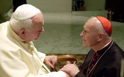 US Cardinal Theodore Edgar McCarrick, archbishop of Washington, DC (left) shakes hands with Pope John Paul II during the General Audience with the newly appointed cardinals in the Paul VI hall at the Vatican, February 23, 2001 (AP Photo/Massimo Sambucetti)