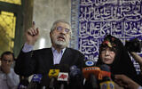 Leading challenger and reformist candidate Mir Hossein Mousavi speaks to the media after casting his vote with his wife Zahra Rahnavard, right, in the Iranian presidential elections at the Ershad mosque, on the outskirts of Tehran, Iran, June 12, 2009. (AP Photo/Ben Curtis)