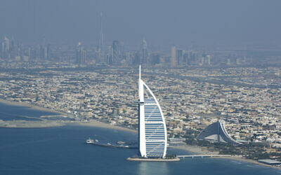 Burj Al Arab, a luxury hotel, foreground, and Burj Dubai, the world's tallest building, in background center, seen from a plane in Dubai, United Arab Emirates, January 3, 2010. (AP Photo/Kamran Jebreili/File)
