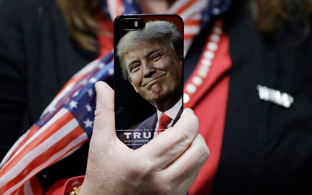 A woman holds up her cell phone before a rally with then presidential candidate Donald Trump in Bedford, New Hampshire, September 29, 2016. (AP Photo/John Locher, File) A woman holds up her cell phone before a rally with then presidential candidate Donald Trump in Bedford, New Hampshire, September 29, 2016. (AP Photo/John Locher, File)