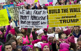 Women with bright pink hats and signs begin to gather early and are set to make their voices heard on the first full day of Donald Trump's presidency, Jan. 21, 2017 in Washington (AP Photo/Jose Luis Magana)