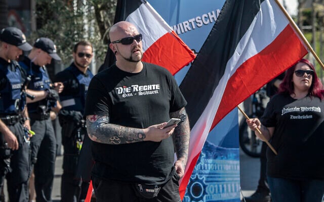 Illustrative -- A man participates in a demonstration of the German far-right party 'Die Rechte' in Ingelheim, Germany, April 20, 2019. (Boris Roessler/dpa via AP) Illustrative -- A man participates in a demonstration of the German far-right party 'Die Rechte' in Ingelheim, Germany, April 20, 2019. (Boris Roessler/dpa via AP)