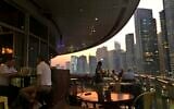 People enjoy drinking alcoholic beverages at a restaurant overlooking the Marina district in Dubai, United Arab Emirates, Oct. 23, 2019 (AP Photo/Kamran Jebreili)