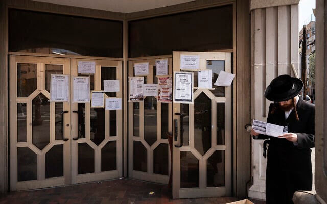 Illustrative: An ultra-Orthodox man stops to read an announcement at a closed synagogue in the Williamsburg neighborhood of Brooklyn, in New York, April 7, 2020. (Mark Lennihan/AP) Illustrative: An ultra-Orthodox man stops to read an announcement at a closed synagogue in the Williamsburg neighborhood of Brooklyn, in New York, April 7, 2020. (Mark Lennihan/AP)