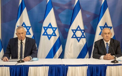 Prime Minister Benjamin Netanyahu, right, and Defense Minister Benny Gantz issue a statement at the Defense Ministry in Tel Aviv, July 27, 2020. (AP Photo/Tal Shahar, Yediot Ahronoth, Pool)
