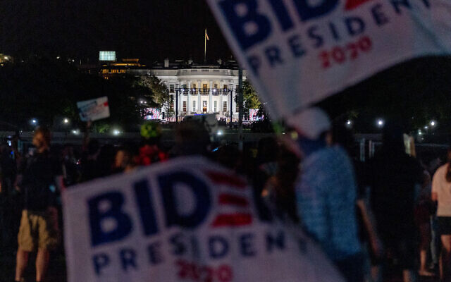 Illustrative: Biden supporters hold banners near the White House, August 27, 2020, in Washington. (AP Photo/Andrew Harnik) Illustrative: Biden supporters hold banners near the White House, August 27, 2020, in Washington. (AP Photo/Andrew Harnik)