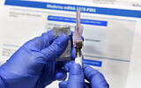 A nurse prepares a shot in a study of a COVID-19 vaccine developed by the National Institutes of Health and Moderna Inc. in Binghamton, New York, July 27, 2020. (AP Photo/Hans Pennink)