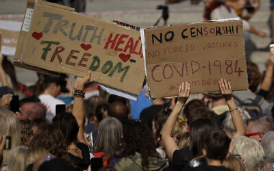 FILE -- People take part in a 'Resist and Act for Freedom' protest against a mandatory coronavirus vaccine, wearing masks, social distancing and a second lockdown, in Trafalgar Square, London, Sept. 19, 2020. (AP Photo/Matt Dunham)