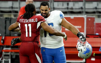Arizona Cardinals wide receiver Larry Fitzgerald (11) greets Detroit Lions offensive guard Oday Aboushi (76) after an NFL football game, September 27, 2020, in Glendale, Arizona. (AP Photo/Rick Scuteri)