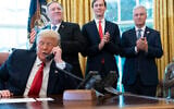 US President Donald Trump talks on the phone with the leaders of Sudan and Israel, as Secretary of State Mike Pompeo, left, White House senior adviser Jared Kushner, and National Security Adviser Robert O'Brien, applaud in the Oval Office, October 23, 2020. (AP Photo/Alex Brandon)