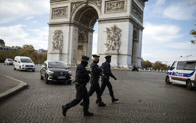 Police officers patrol by the Arc de Triomphe near the Champs Elysees avenue in Paris, Oct. 31, 2020 (AP Photo/Lewis Joly) Police officers patrol by the Arc de Triomphe near the Champs Elysees avenue in Paris, Oct. 31, 2020 (AP Photo/Lewis Joly)