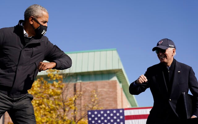 US Democratic presidential candidate former Vice President Joe Biden, right, and former President Barack Obama greet each other with an air elbow bump, at the conclusion of rally at Northwestern High School in Flint, Michigan, October 31, 2020. (AP Photo/Andrew Harnik) US Democratic presidential candidate former Vice President Joe Biden, right, and former President Barack Obama greet each other with an air elbow bump, at the conclusion of rally at Northwestern High School in Flint, Michigan, October 31, 2020. (AP Photo/Andrew Harnik)