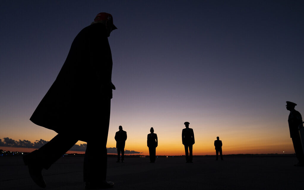 US President Donald Trump walks away after speaking with reporters at Charlotte Douglas International Airport, Sunday, Nov. 1, 2020, in Charlotte, NC. (AP Photo/Evan Vucci) US President Donald Trump walks away after speaking with reporters at Charlotte Douglas International Airport, Sunday, Nov. 1, 2020, in Charlotte, NC. (AP Photo/Evan Vucci)