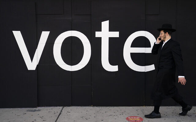 A US Jewish man walks past a boarded-up store with the word "Vote" painted on it ahead of Election Day, November 2, 2020, in Los Angeles. (AP Photo/Jae C. Hong) A US Jewish man walks past a boarded-up store with the word "Vote" painted on it ahead of Election Day, November 2, 2020, in Los Angeles. (AP Photo/Jae C. Hong)