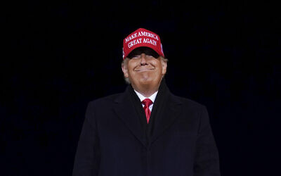 US President Donald Trump smiles at supporters after a campaign rally at Gerald R. Ford International Airport, November 3, 2020, in Grand Rapids, Michigan. (AP Photo/Evan Vucci)