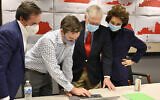 Republican Senate candidate Sen. Mitch McConnell, second from right, and his wife, Elaine Chao, right, look on as aides show him the election results in Louisville, Kentucky, Nov. 3, 2020. (AP Photo/Timothy D. Easley)