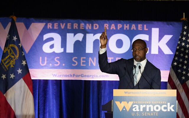 Raphael Warnock, a Democratic candidate for the US Senate, speaks during a rally on November 3, 2020, in Atlanta. (AP Photo/Brynn Anderson, Pool) Raphael Warnock, a Democratic candidate for the US Senate, speaks during a rally on November 3, 2020, in Atlanta. (AP Photo/Brynn Anderson, Pool)