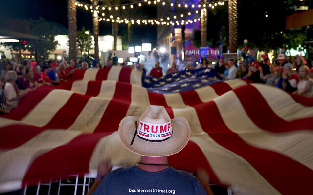 US President Donald Trump supporters wave a flag during an election watch party, Nov. 3, 2020, in Chandler, Arizona (AP Photo/Matt York) US President Donald Trump supporters wave a flag during an election watch party, Nov. 3, 2020, in Chandler, Arizona (AP Photo/Matt York)