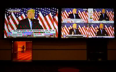 A live broadcast of President Donald Trump speaking from the White House is shown on screens at an election night party, Tuesday, Nov. 3, 2020, in Las Vegas. (AP/John Locher)