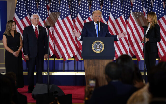 US President Donald Trump speaks in the East Room of the White House, early November 4, 2020, in Washington, as Vice President Mike Pence and Karen Pence and First Lady Melania Trump listen. (AP Photo/ Evan Vucci) US President Donald Trump speaks in the East Room of the White House, early November 4, 2020, in Washington, as Vice President Mike Pence and Karen Pence and First Lady Melania Trump listen. (AP Photo/ Evan Vucci)