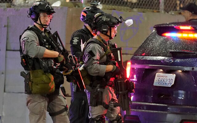Illustrative: Police officials stand guard during a protest after the Nov. 3 elections, Wednesday, Nov. 4, 2020, in Seattle. (AP Photo/Ted S. Warren) Illustrative: Police officials stand guard during a protest after the Nov. 3 elections, Wednesday, Nov. 4, 2020, in Seattle. (AP Photo/Ted S. Warren)
