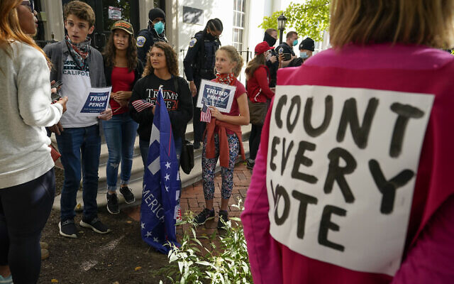 Trump supporters argue their points with demonstrators from the organization Code Pink outside the Republican National Committee headquarters, Thursday, Nov. 5, 2020, on Capitol Hill in Washington. (AP/Alex Brandon) Trump supporters argue their points with demonstrators from the organization Code Pink outside the Republican National Committee headquarters, Thursday, Nov. 5, 2020, on Capitol Hill in Washington. (AP/Alex Brandon)