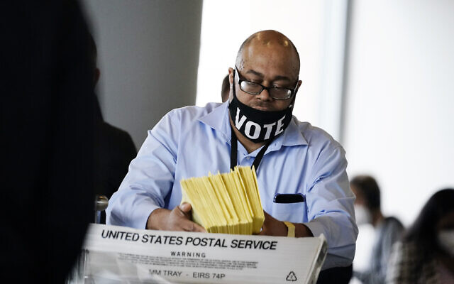 A election worker hands out ballots to be counted at State Farm Arena on Thursday, Nov. 5, 2020, in Atlanta. (AP Photo/Brynn Anderson) A election worker hands out ballots to be counted at State Farm Arena on Thursday, Nov. 5, 2020, in Atlanta. (AP Photo/Brynn Anderson)