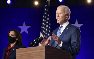 Democratic vice presidential candidate Kamala Harris, left, listens as Democratic presidential candidate Joe Biden speaks on November 6, 2020, in Wilmington, Delaware. (AP Photo/Carolyn Kaster)