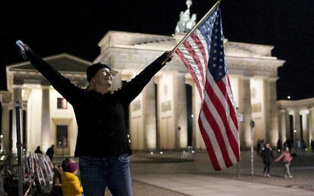 Marianne Hoenow from Connecticut in the US celebrates the victory of President-elect Joe Biden and Vice President-elect Kamala Harris in front of the Brandenbug Gate next to the United States embassy in Berlin, Germany, Saturday, Nov. 7, 2020. (AP/Markus Schreiber) Marianne Hoenow from Connecticut in the US celebrates the victory of President-elect Joe Biden and Vice President-elect Kamala Harris in front of the Brandenbug Gate next to the United States embassy in Berlin, Germany, Saturday, Nov. 7, 2020. (AP/Markus Schreiber)