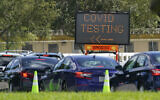 Cars line up at a COVID-19 testing site at Tropical Park, Saturday, Nov. 14, 2020, in Miami. (AP Photo/Wilfredo Lee)