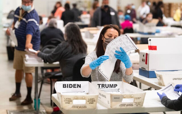 An election worker looks at a ballot during a Cobb County hand recount of Presidential votes on Nov.15, 2020, at the Miller Park Event Center in Marietta, Ga. (JOHN AMIS FOR THE ATLANTA JOURNAL-CONSTITUTION) An election worker looks at a ballot during a Cobb County hand recount of Presidential votes on Nov.15, 2020, at the Miller Park Event Center in Marietta, Ga. (JOHN AMIS FOR THE ATLANTA JOURNAL-CONSTITUTION)