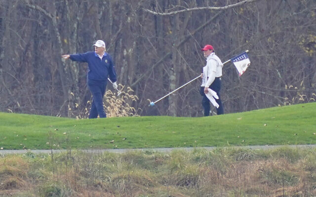 US President Donald Trump, left, gesturing while playing golf at Trump National Golf Club in Sterling, Virginia, November 15, 2020. (Manuel Balce Ceneta/AP) US President Donald Trump, left, gesturing while playing golf at Trump National Golf Club in Sterling, Virginia, November 15, 2020. (Manuel Balce Ceneta/AP)