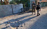 Security forces inspect the scene of the rocket attack at the gate of al-Zawra public park in Baghdad, Iraq, November 18, 2020. (AP Photo/Khalid Mohammed)