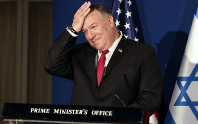 US Secretary of State Mike Pompeo pats his head during a joint press conference with Benjamin Netanyahu and Bahrain's Foreign Minister Abdullatif bin Rashid Alzayani after their trilateral meeting in Jerusalem on Wednesday, Nov. 18, 2020. (Menahem Kahana/Pool via AP)