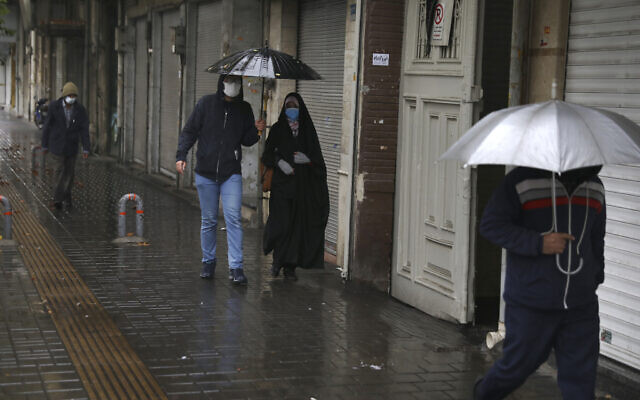 People walk in front of closed shops at Tehran's Grand Bazaar, Iran's main business and trade hub, Nov. 21, 2020 (AP Photo/Vahid Salemi) People walk in front of closed shops at Tehran's Grand Bazaar, Iran's main business and trade hub, Nov. 21, 2020 (AP Photo/Vahid Salemi)