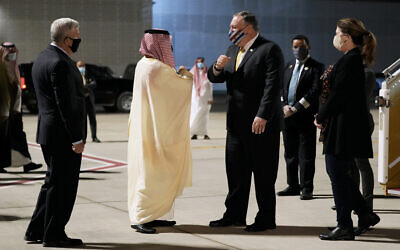 US Ambassador to Saudi Arabia John Abizaid, left, and Saudi Arabia's Foreign Minister Faisal bin Farhan, second from left, greet Secretary of State Mike Pompeo and his wife Susan as they arrive at Neom Bay Airport in Neom, Saudi Arabia, Sunday, Nov. 22, 2020. (AP Photo/Patrick Semansky, Pool)