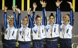 Israel's rhythmic gymnastics team wave from the podium before receiving their gold medals during the 36th European Rhythmic Gymnastics Championships in Kyiv, Ukraine, Friday, Nov. 27, 2020 (AP Photo/Efrem Lukatsky)
