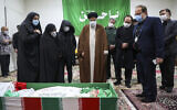 Iran's Judiciary Chief Ayatollah Ebrahim Raisi pays his respect to the body of slain scientist Mohsen Fakhrizadeh among his family, in Tehran, Iran, November 28, 2020. (Mizan News Agency via AP)