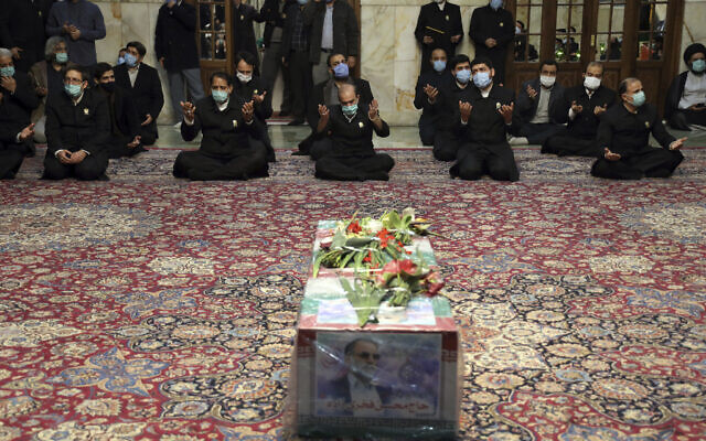 In this picture released by the Iranian Defense Ministry and taken on Saturday, Nov. 28, 2020, people pray over the flag draped coffin of Mohsen Fakhrizadeh, an Iranian scientist linked to the country's military nuclear program,(Iranian Defense Ministry via AP) In this picture released by the Iranian Defense Ministry and taken on Saturday, Nov. 28, 2020, people pray over the flag draped coffin of Mohsen Fakhrizadeh, an Iranian scientist linked to the country's military nuclear program,(Iranian Defense Ministry via AP)