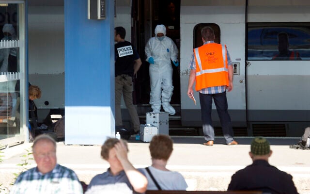 People wait for a train in the foreground as members of a police forensics team take part in an investigation next to a Thalys train on the platform at Arras train station, northern France, August 22, 2015. (Virginia Mayo/AP) People wait for a train in the foreground as members of a police forensics team take part in an investigation next to a Thalys train on the platform at Arras train station, northern France, August 22, 2015. (Virginia Mayo/AP)