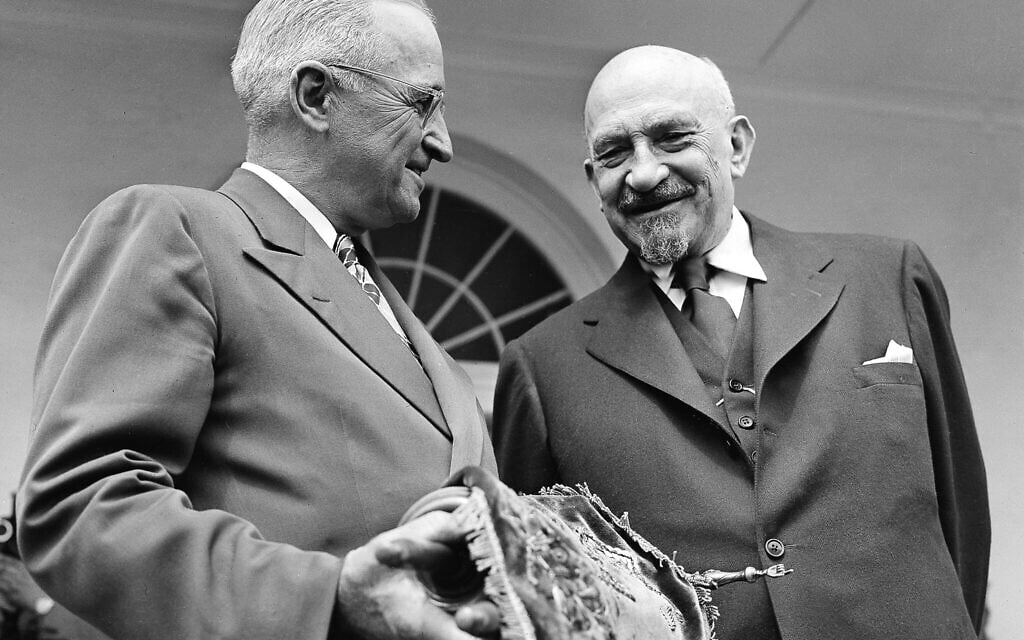 US president Harry S. Truman holds a copy of the Torah, presented to him by Chaim Weizmann, right, in Washington, May 25, 1948. (AP Photo)