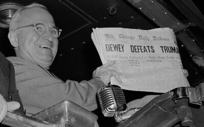Harry S. Truman holds up an Election Day edition of the Chicago Daily Tribune, which, based on early results, mistakenly announced 'Dewey Defeats Truman' on November 4, 1948. (AP Photo/Byron Rollins)