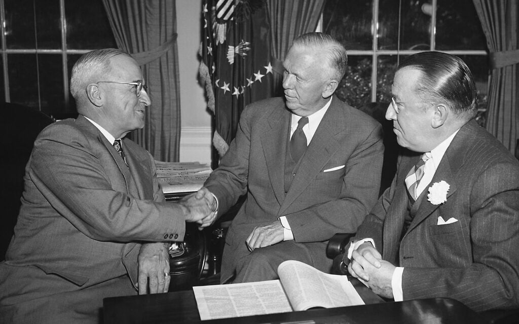 Then-president Harry Truman, left, congratulates George Marshall, center, after the former Secretary of State became chairman of the American Red Cross at the White House, October 3, 1949. (AP Photo)