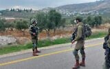 Israeli soldiers stand on a road in the central West Bank where two improvised explosive devices were uncovered on November 22, 2020. (Israel Defense Forces)