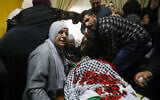 Relatives of Ahmad Jamal Manasrah, 26, mourn near his body during his funeral ceremony in the West Bank village of Wad Fokin, near Bethlehem on March 21, 2019. ( Wisam Hashlamoun/Flash90)