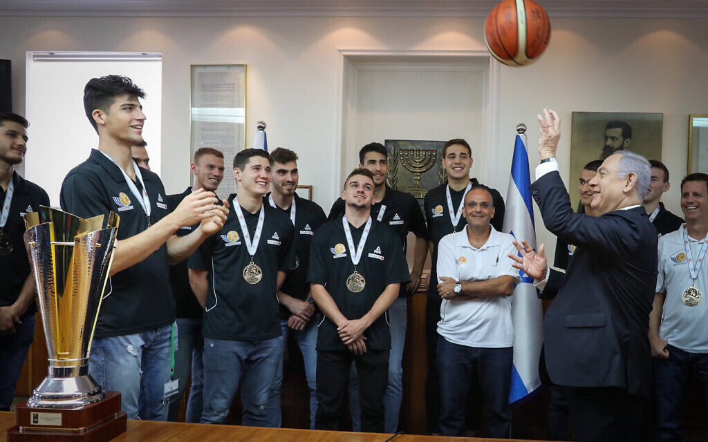 Prime Minister Benjamin Netanyahu and Deni Avdija after the Israel youth basketball team's victory at the FIBA European Championships, at the Prime Minister's Office on July 24, 2019 (Marc Israel Sellem/POOL)
