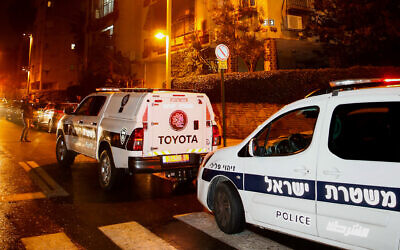 Illustrative: Police and medical personnel at the scene where police were investigating a suspected murder-suicide in Petah Tikva, January 17, 2020. (Roy Alima/Flash90)