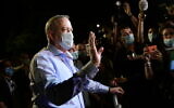 Minister of Defense Benny Gantz speaks to the media and protesters outside his home, during a demonstration of Israeli workers from the culture and art industry in Rosh Haayin, on August 9, 2020.(Tomer Neuberg/Flash90)