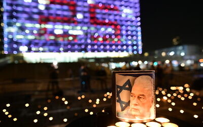 Israelis light candles, as part of a display of 25,000 memorial candles in honor of the 25th Memorial Day for the assassination of late prime minister Yitzhak Rabin, at Rabin Square in Tel Aviv on October 29, 2020.(Tomer Neuberg/Flash90)